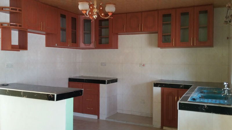 Open plan kitchen, fully tiled with inbuilt mdf cabinets